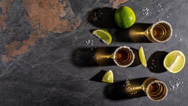 istock Tequila shot with lime and sea salt on stone background. space for text. concept luxury drink. Alcoholic drink concept. Mexican national drink. Long banner format 1400938671