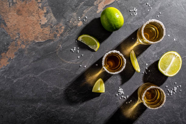 istock Mexican tequila with lime and salt on black background. space for text. concept luxury drink. Alcoholic drink. 1400938678