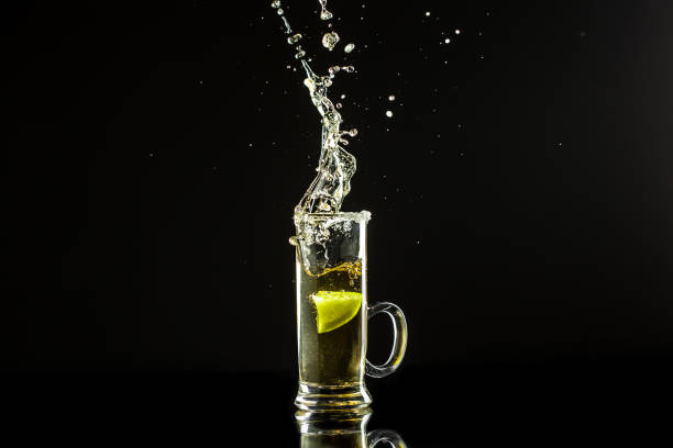 istock Mexican tequila with lime on black background. space for text. concept luxury drink. Alcoholic drink concept. Freeze motion, drops in liquid splash Mexican national drink 1400938691