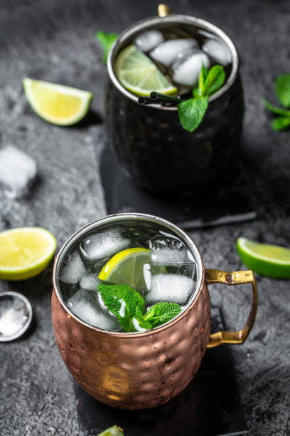 istock two Icy Cold moscow mules cocktail with ginger beer, vodka, lime. banner, menu recipe, top view 1400940036