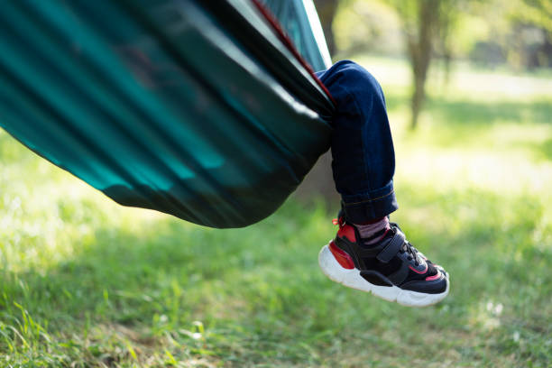 istock Child with only feet visible sits in hammock 1400942633