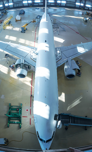 Frontal close-up view of two-storey jumbo jet on a ground on a sunny day.