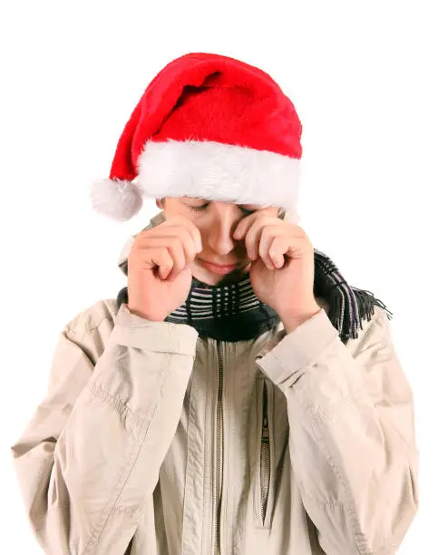 Sad Young Man in Santa's Hat Isolated On The White Background