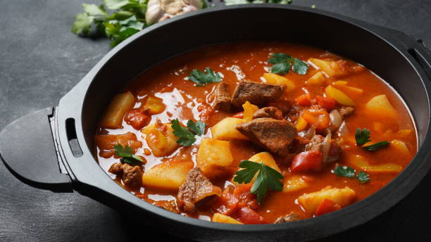Beef goulash, soup and a stew, made of beef chuck steak, potatoes and plenty of paprika. Hungarian  traditional meal. Beef goulash, soup and a stew, made of beef chuck steak, potatoes and plenty of paprika. Hungarian  traditional meal. hungarian culture stock pictures, royalty-free photos & images