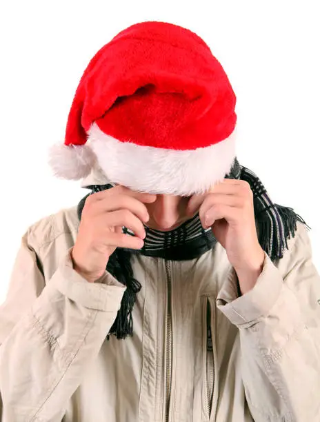 Sad Young Man in Santa's Hat Isolated On The White Background