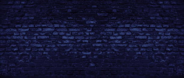 istock Navy blue old shabby brick wall wide texture. Dark rough brickwork abstract backdrop. Gloomy grunge indigo color panoramic background 1400945456