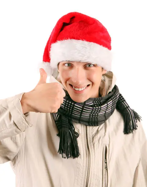Cheerful Young Man in Santa's Hat with OK Gesture Isolated On The White Background