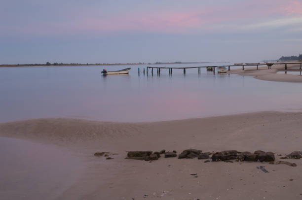 istock Senegal River with boats in a dock at sunset. 1400947682