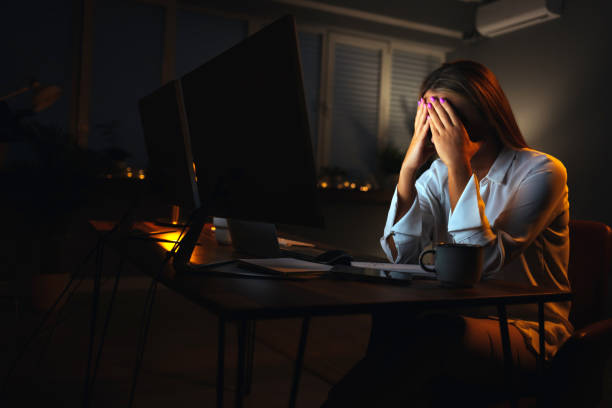 istock Young woman looking stressed out while working on a Desktop PC at home at night 1400950007