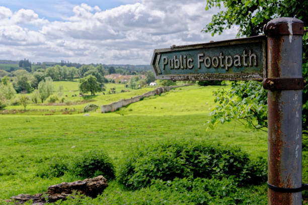 istock Footpath sign pointing over a traditional hay meadow in Chipping Campden 1400950642