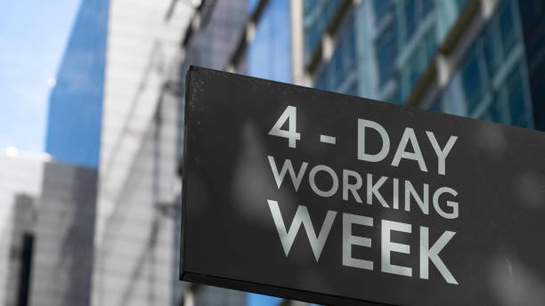 4 - Day working week on a black city-center sign in front of a modern office building 4 - Day working week on a black city-center sign in front of a modern office building day stock pictures, royalty-free photos & images