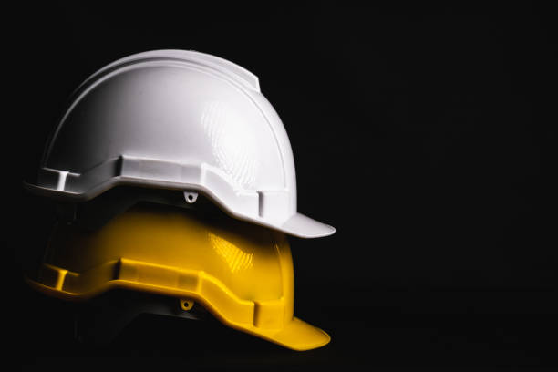 istock Safety helmet engineer white and yellow on black background. 1400956145