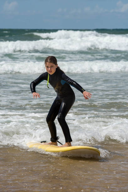 istock pretty girl enjoying her surf lesson 1400957120