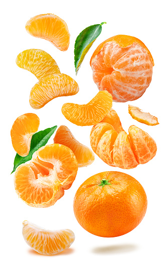 Levitating ripe tangerine fruits, leaves and mandarin slices on white background. File contains clipping paths.