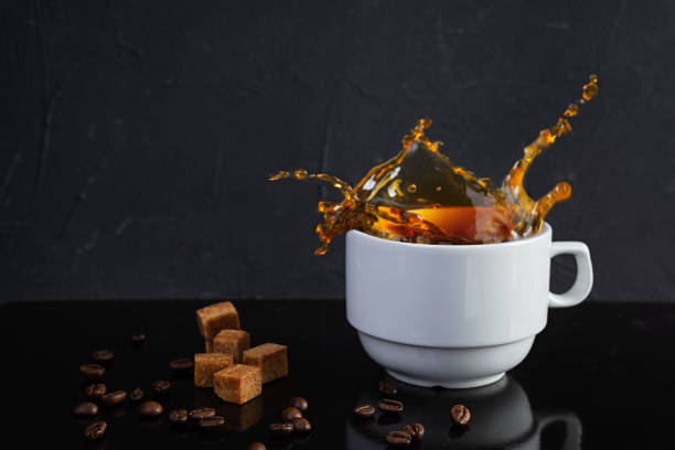 istock Cup of coffee with sugar and coffee beans on dark background 1400958363