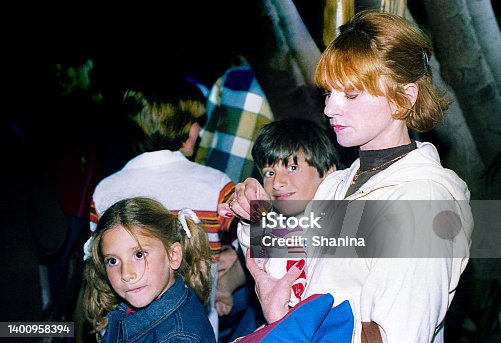 istock Mother and kids in the crowd outdoors 1400958394