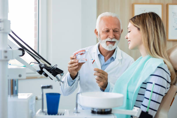 istock Dentist explaining the teeth washing with electric toothbrush 1400960047