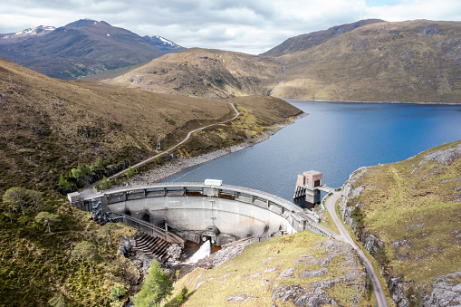 An aerial drone photograph of a hydro electric dam in the Scottish Highlands. Scotland's hydro power supplies 85% of the UK's hydro electric power, providing a valuable renewable resource, as part of the country's aim to produce more sustainable energy.