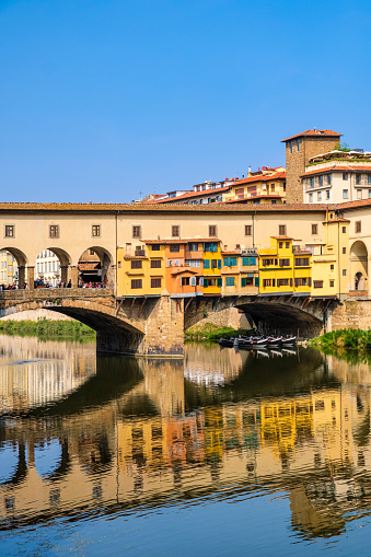 Tourists on the famous Ponte Vecchio - Old Bridge - of Florence, a medieval stone closed bridge over the Arno River that is one of the historic landmarks of the city