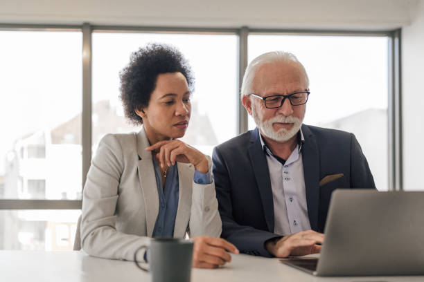 istock Focused partners analyzing business strategy on laptop during office meeting 1400967286