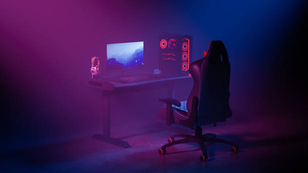 Gaming Desk Gamer computer and equipments on the gaming desk under the neon colored spotlights. gaming chair photos stock pictures, royalty-free photos & images