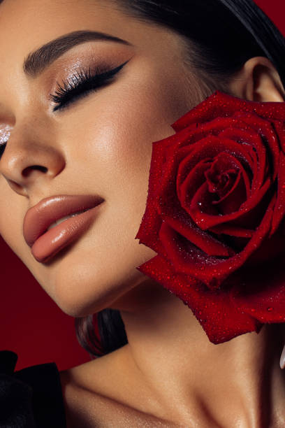 istock Beautiful woman holding red rose 1400969797