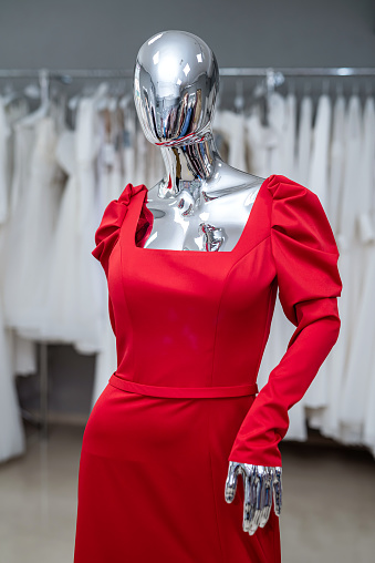 evening cocktail red dress on a mannequin in the salon. fashion concept