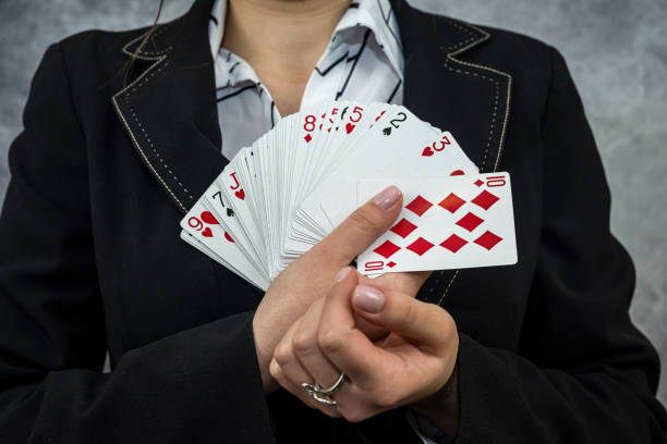 istock woman in suit shows a winning combination on cards 1400973621