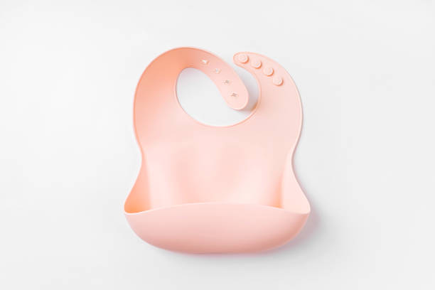 istock Pink silicone baby bib  on white background. Top view, flat lay 1400974005