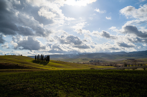 Beautiful view at Val d'Orcia against moody clouds. Panoramic shot. Italy, Tuscany