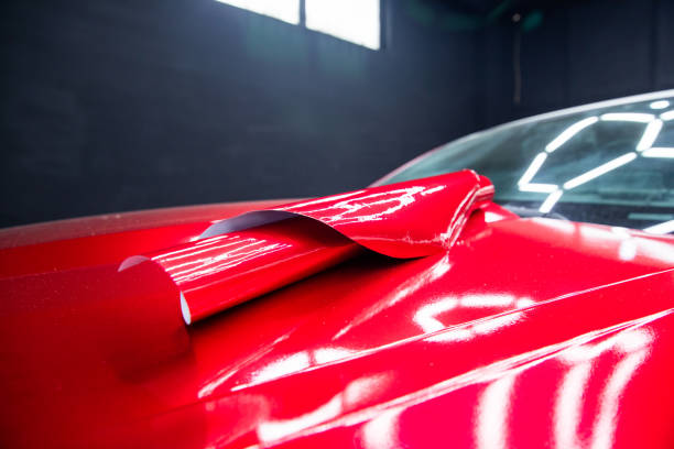 istock Car wrapping, squeegee installs film 1400975619