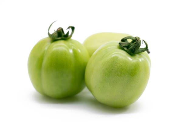 istock Fresh green unripe tomato isolated on white background. 1400975627