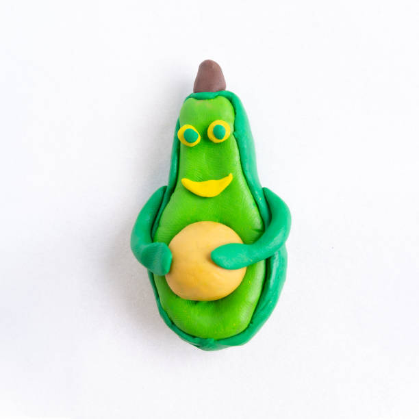 istock avocado figurine made of plasticine. character concept. 1400975947
