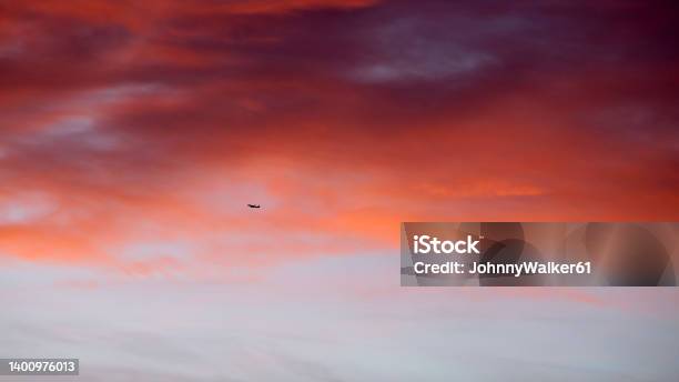 Airplane Against Red Morning Clouds Stock Photo - Download Image Now - Airplane, Beauty, Business