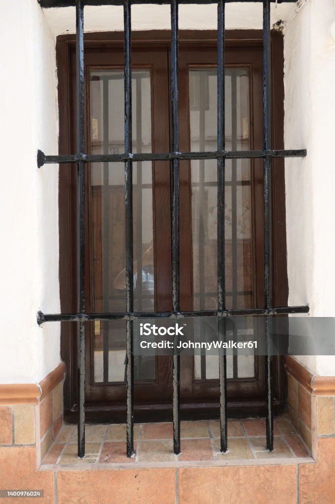 Wrought Iron Grill or bars on Window Wrought Iron Grill or bars on Window in Andalusian village Andalusia Stock Photo