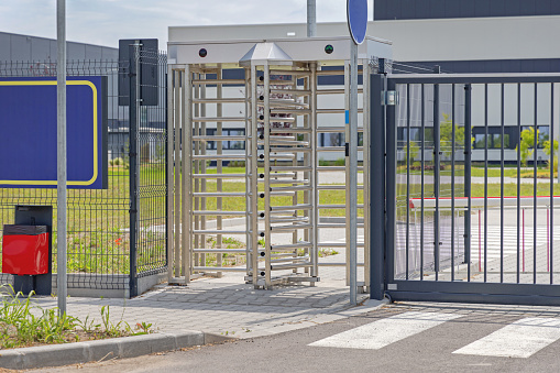 Employee Entrance Turnstile Doors at Factory Gate Fence