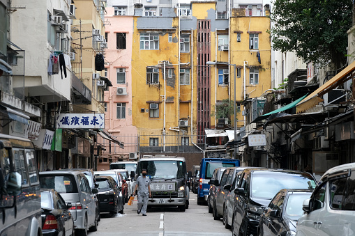 Man walking on a street in Hung Hom, an area of Kowloon, in Hong Kong, administratively part of the Kowloon City District.