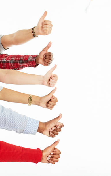 Enthusiastic thumbs-up gesture by a group of six people.