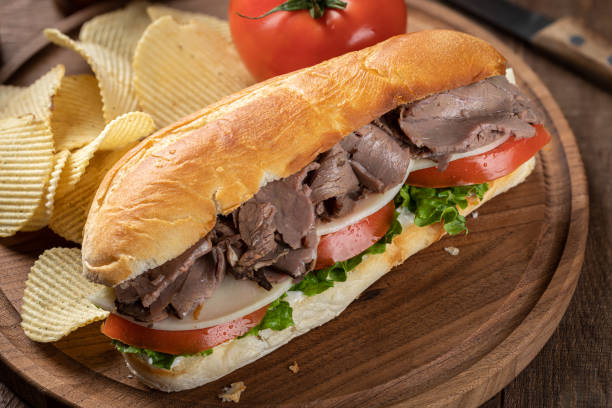 istock Submarine sandwich with roast beef, cheese, tomato and lettuce 1400980768