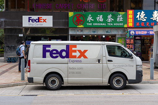 Hong Kong - June 4, 2022 : FedEx Express van at the FedEx Ship Center in Tsim Sha Tsui, Kowloon, Hong Kong.