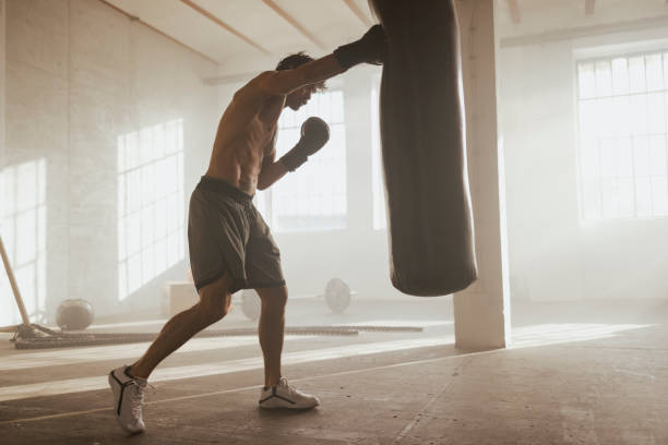 istock Fit young man boxing in the gym 1400982443