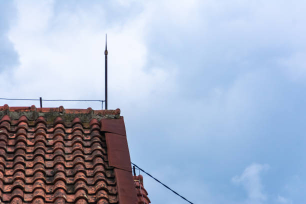 istock house rooftile with the lightning rod stand upside under the bright blue sky 1400983340