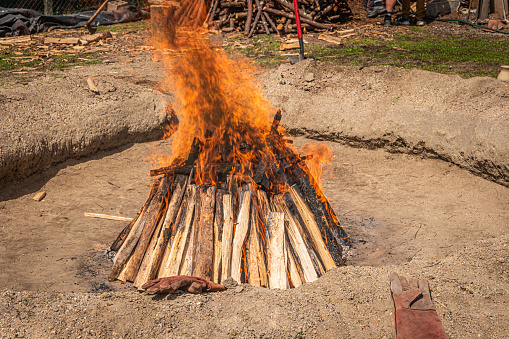 Preparation of the bonfire during the cooking process of the black clay of Gondar in Amarante, Portugal.