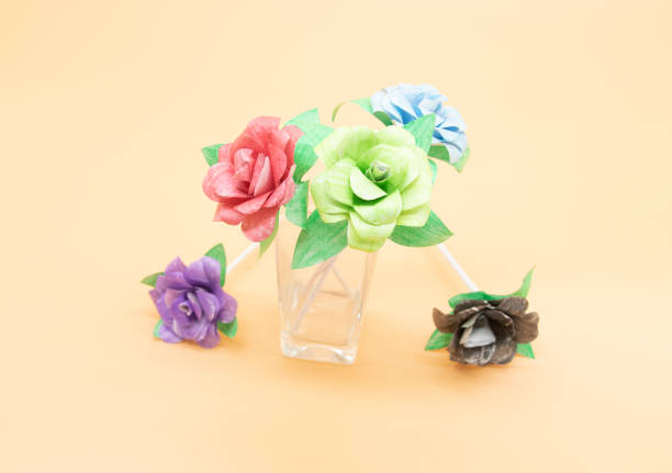 istock paper made rose in different color isolate on colorful background 1400985914