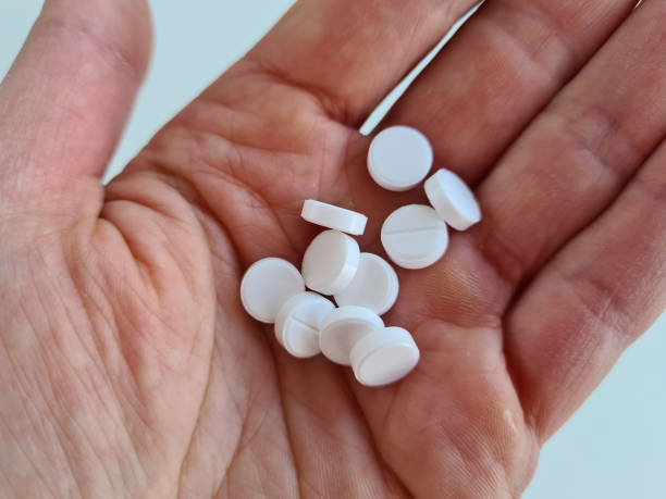 istock Hands with antibacterial medicine and white pills closeup 1400986341