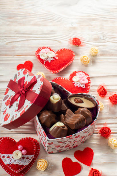 istock Chokolate box in shape of heart on white wooden table valentine background low angle view 1400987517