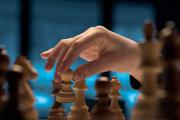 istock Chess game tournament: the player is moving a pawn 1400988323