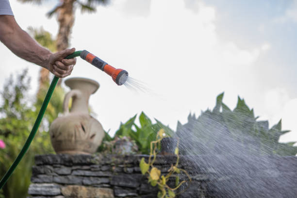 He is using a garden hose