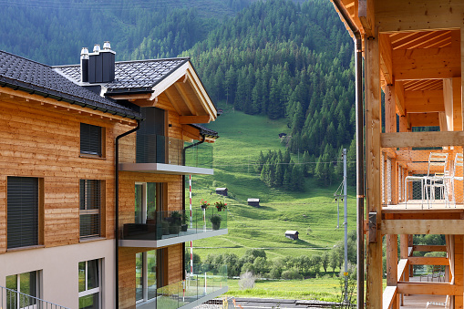 Wooden chalet in Swiss Alps. Green mountain hill on the background. Summer vacations