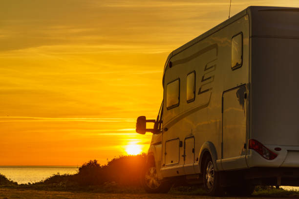 istock Camper vehicle on beach at sunrise 1400989745